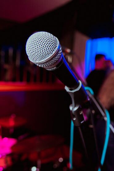 Events Page Preview Image - Microphone with blurred background of the bar area